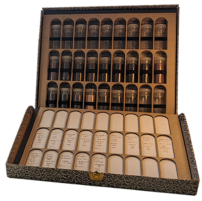 A black and white marbled box filled with small vials filled with dirt